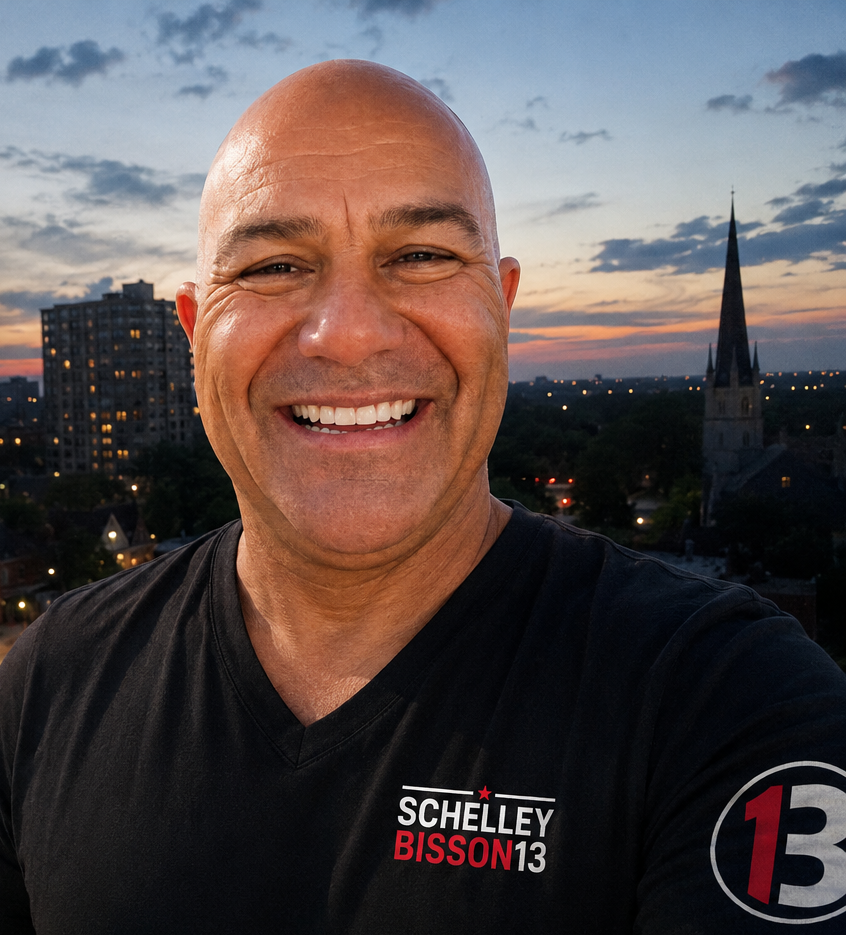 Schelley Bisson, Ward 13 candidate, smiling in front of the London, Ontario dusk skyline — apartment towers, lit streets and St Peter’s spire